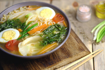 Appetizing Chinese noodle soup with bok choi cabbage. Chinese cuisine.