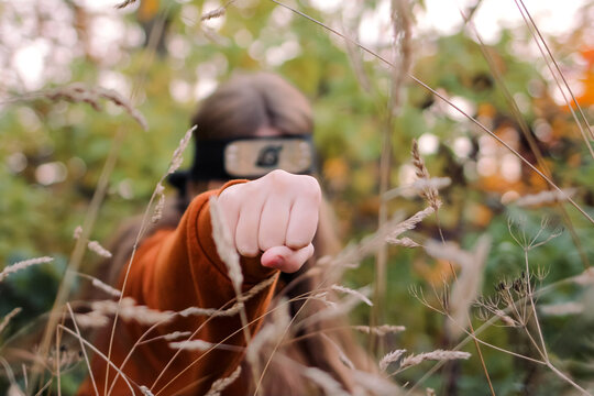 caucasian teenager girl walking in the image of character Naruto from anime