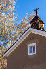Historic adobe church building with steeple