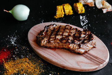 Grilled pork steak on a wooden board