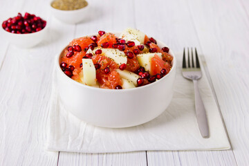 Fresh fruit salad in bowl on wooden table. Concept healthy food, diet, vegan