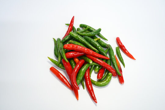 green and red chili peppers on white background