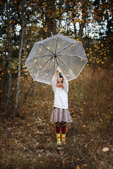 girl 5 years old with umbrella in autumn