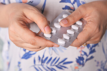 women hand holding blister pack close up 