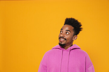 Cheerful african american guy smiling and looking aside