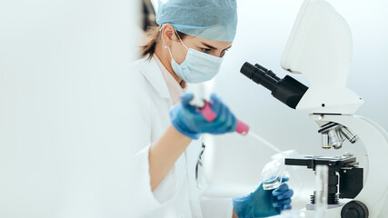 female scientist conducts research in the laboratory.