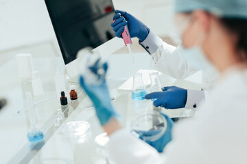 close up. scientists examining liquid samples in the lab.