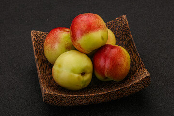 Sweet small nectarines in the basket