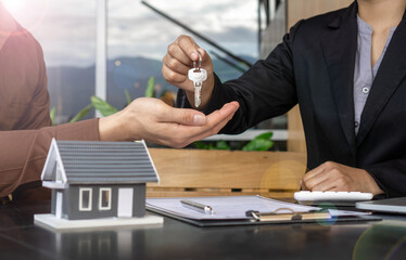The insurance agent handed over the house key to the customer who agreed to buy the house after...