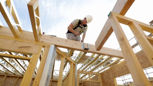 Carpenter constructing timber framed house