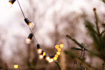 Christmas winter street with tree and festive bokeh lighting, blurred holiday background