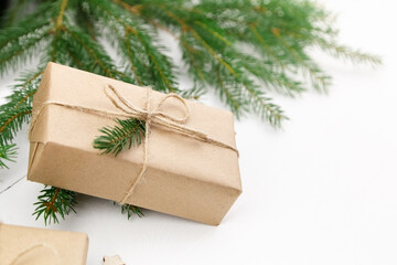 Naklejka na ściany i meble Christmas holidays gift box decorated with fir tree branch.