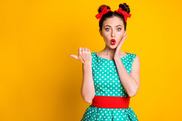 Portrait of lovely amazed wondered girl showing copy space look pout lips isolated over bright yellow color background