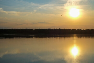 Dramatic and colorful sunset over a forest lake reflected in the water. Blakheide, Beerse, Belgium. High quality photo