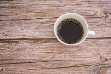white cup of black coffee on wooden table