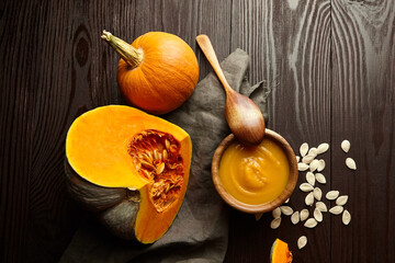 Homemade pumpkin soup with fresh pumpkins and seeds