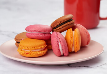 baked macarons on a pink plate