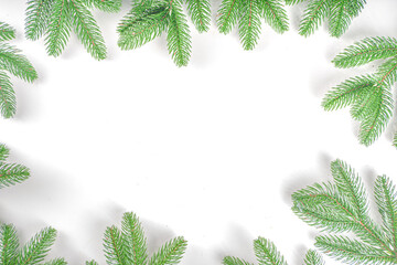 Christmas tree branches background. Fir tree branches flatlay on white table, greeting card background top view frame