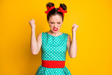 Photo of angry girl raise fists feel frustration wear teal clothes isolated over vivid color background