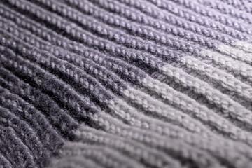 Fototapeta na wymiar Gray two tone wool scarf background texture. Handmade product, closeup, selective focus