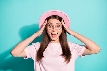 Photo of shiny funny girl lady dressed pink t-shirt retro cap open mouth arms head isolated turquoise color background
