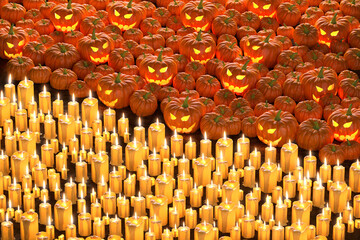 Obraz premium Halloween day concept on black background.big pumpkin with an orange light devil smile face.big candle and light on the dirt ground. black copy space. night decoration design. 3d illustrator.