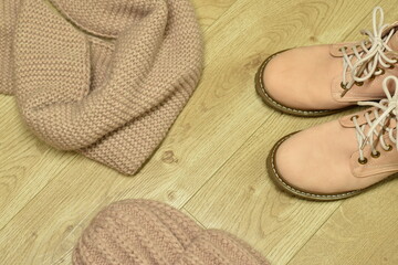 Women's beige accessories - winter boots, knitted hat and scarf.