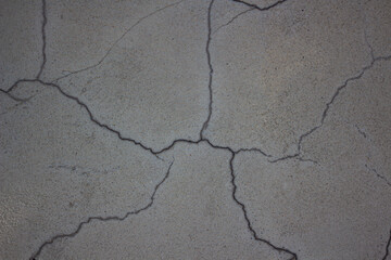 Obraz premium The texture of a light cracked plaster wall. background