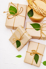 Zero waste gift concept with craft boxes and green leaves