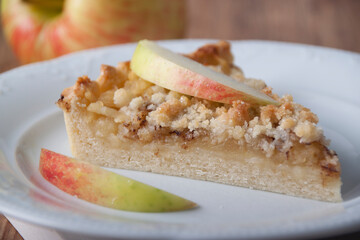 Piece of pie with apples and apple wedge