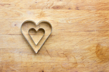 Cookie mold hearts with wooden background