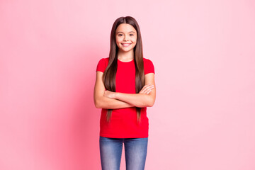 Photo of charming sweet little lady long hairstyle folded hands confident self-assured toothy shiny smile wear casual stylish red t-shirt jeans isolated pink color background