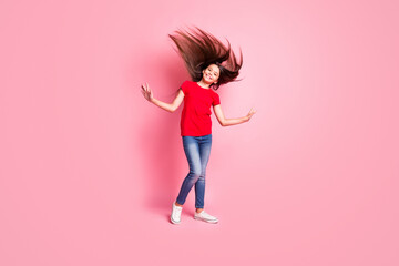 Full length photo of cheerful kid girl her hairstyle blowing by wind wear casual style clothes isolated over pink color background