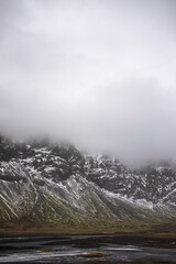 Fog over snow covered mountains in iceland