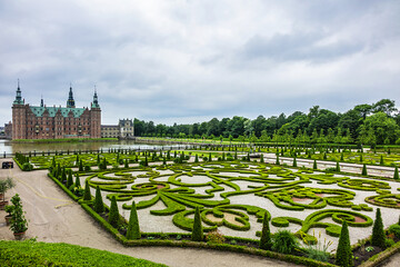 Beautiful garden in Frederiksborg Castle (Frederiksborg Slot, XVII century) - palace in Hillerod, Denmark. Frederiksborg Castle built as royal residence for King Christian IV of Denmark-Norway.