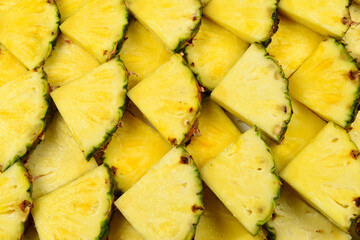 Pineapple juicy yellow slices background. Top view.