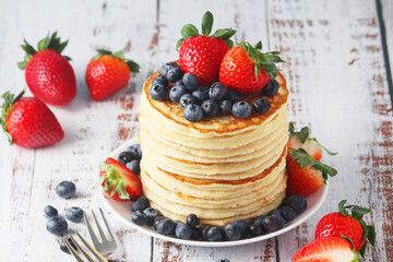 A stack if home-made pancakes with berry