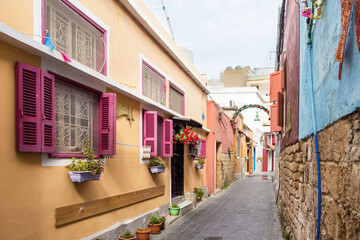 Fototapeta premium Small alleyway with colorful houses, Christian quarter in the Mediterranean coastal town Tyre, Lebanon