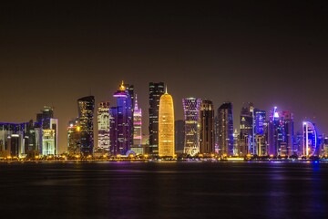 DOHA, QATAR - OCTOBER 27, 2017: Great high skyscrapers of Doha business city center at night. Qatar.