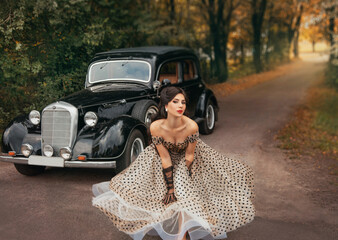 Young beautiful happy retro woman near the old car. Attractive elegant lady in vintage white polka...