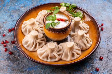 National Georgian cuisine. Khinkali with meat. Khinkali on a wooden board close-up.