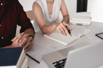 Young woman and man studying for a test or exam Tutor books with friends catching up and learning, education and school concept.