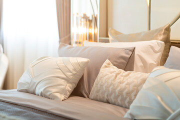 close up white beige soft pillows on bed and blanket bedroom interior design concept.bed maid luxury ideas concept