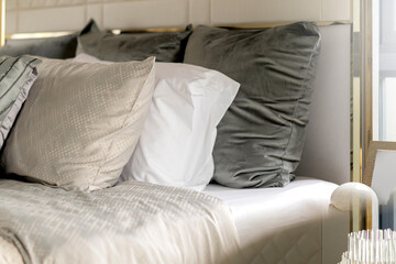 close up white beige soft pillows on bed and blanket bedroom interior design concept.bed maid luxury ideas concept