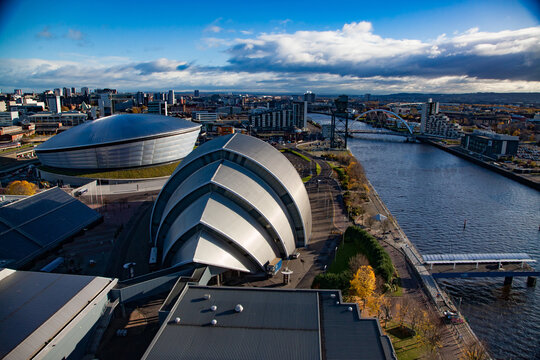Glasgow / Scotland - Nov 13, 2013: Fall in the city. SEC Armadillo and SSE Hydro modern buildings, Clyde river embankment. Aerial panoramic city view. Blue sky with clouds.