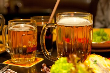 A few big glasses of beer in a restaurant.