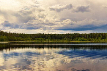 clouds over calm lake Shchuchye Ozero on a sunny day