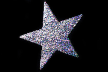 Christmas glitter star isolated on black background. Sequin star for graphical editor and copy space.