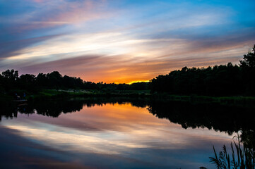 Naklejka na ściany i meble Beautiful colored sunset on the lake