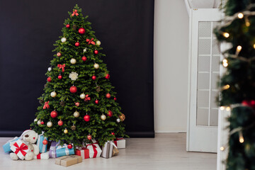 Christmas tree pine with gifts for the new year black decor winter